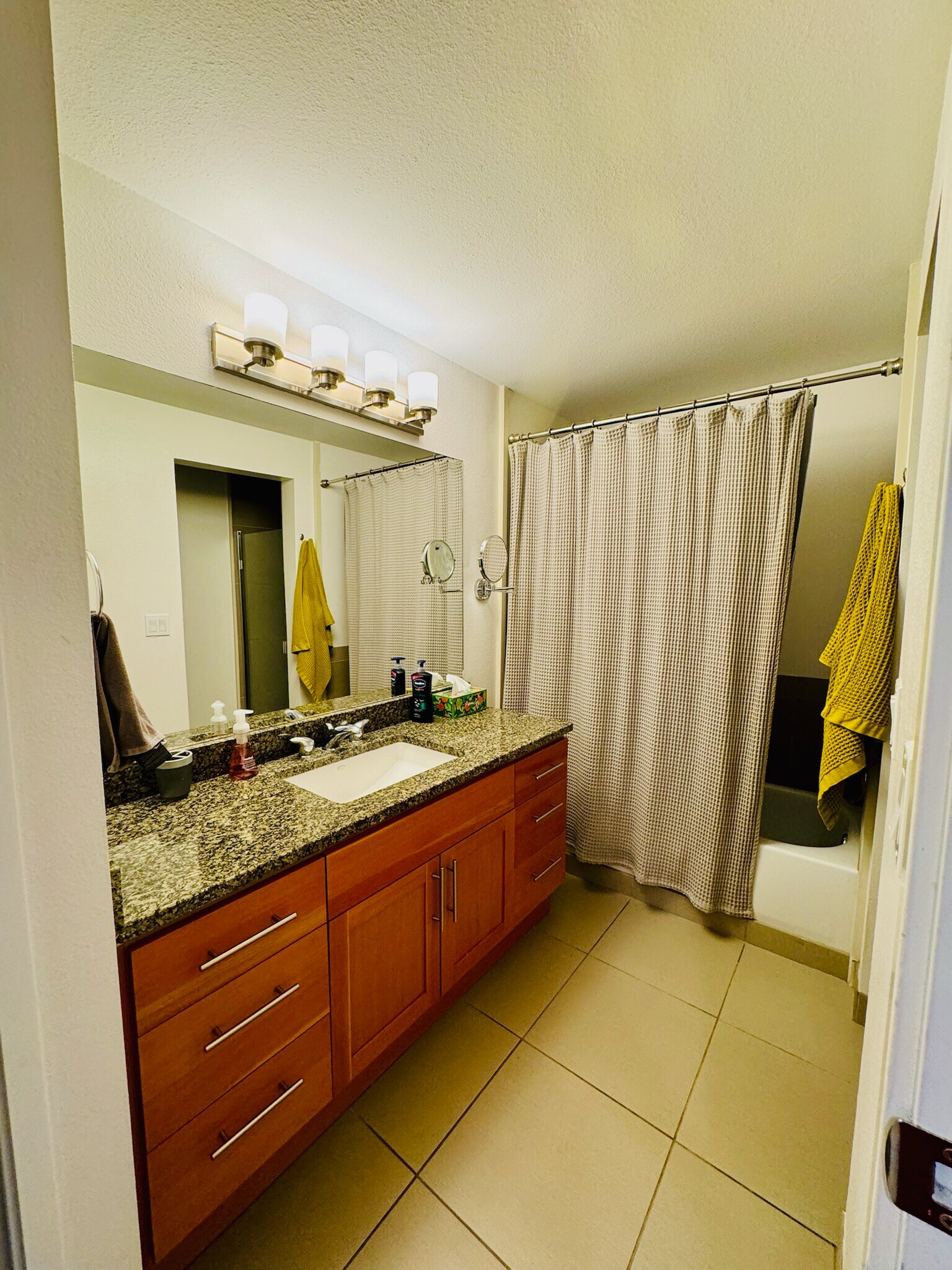 Bright and stylish bathroom with sleek fixtures, ample storage, and elegant finishes - 2145 Dexter Ave N