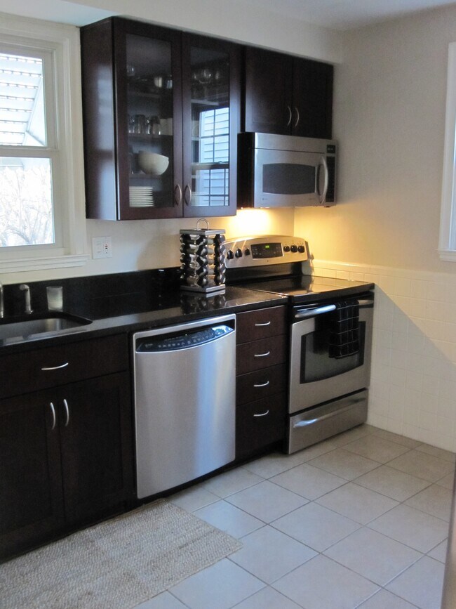 Kitchen with stainless appliances and granite countertop - 8666 Rosalie Ave