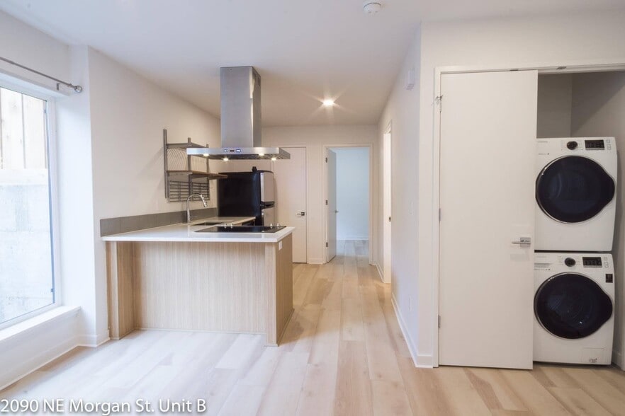Floor to ceiling windows let in lots of natural light. In-unit front loading washer and dryer. - 2090 NE Morgan St