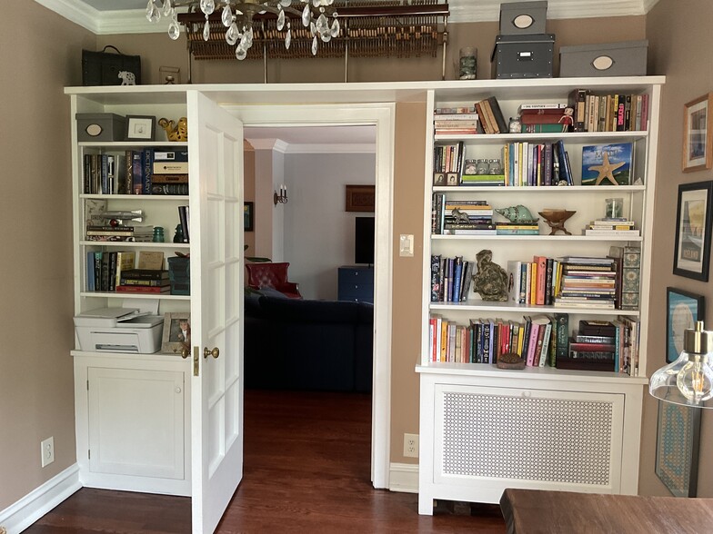 Shelves in the office have plenty of books for reading pleasure! - 825 Forest Ave