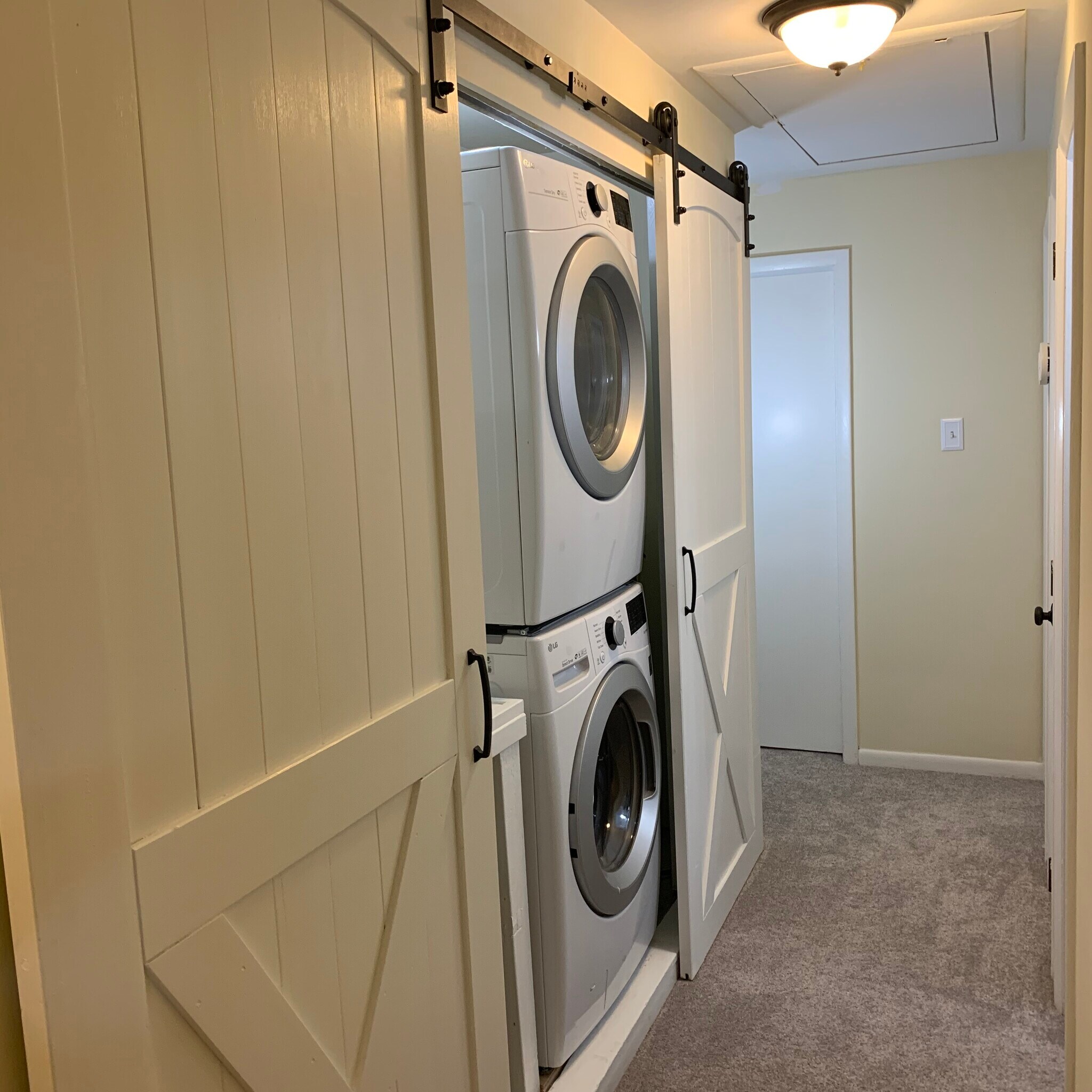 Newly renovated laundry room with rustic barn doors - 1265 Woodmere Rd