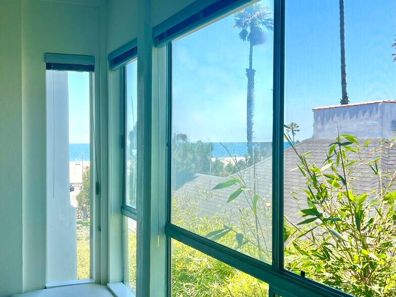 The window seat is the favorite lounging spot to enjoy side views of the ocean and beach. - 2221 Ocean Ave