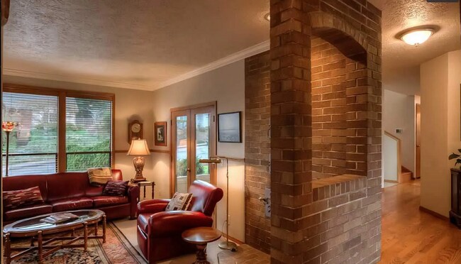 Building Photo - 4bd/3ba HUGE Home w/Hardwood Floors, Russian Fireplace, 2-Car Garage & Fenced Back Yard!