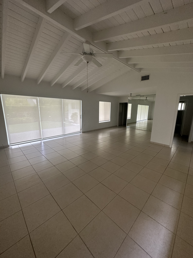 Living room facing dining area and backyard - 5400 Orduna Dr