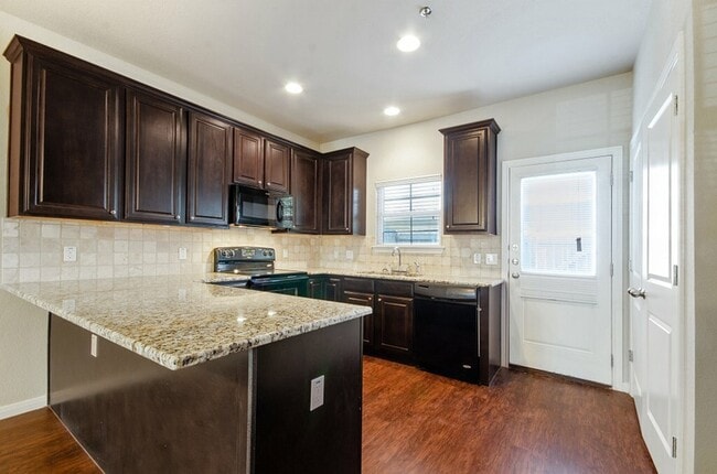 state of the art kitchen with black appliances - Tinsley Place