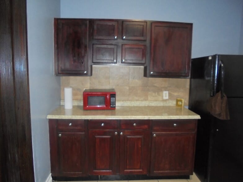 Kitchen with espresso colored wood cabinets - 1610 Homestead st