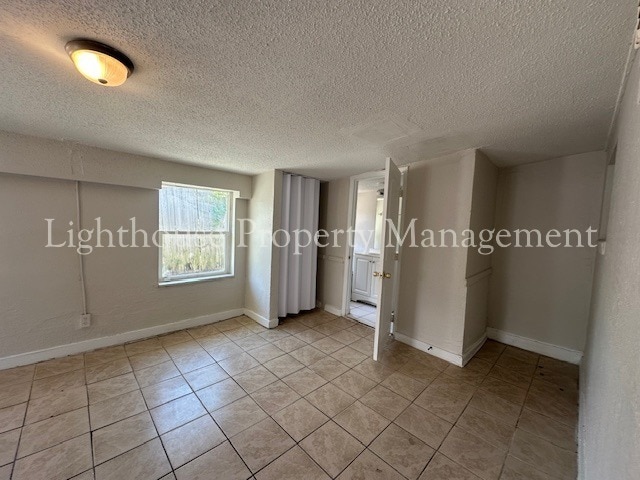 Building Photo - Bright 4 Bedroom Home With Tile Flooring Throughout