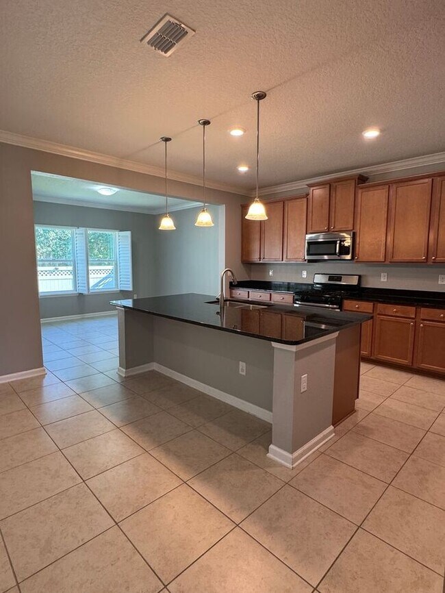 Building Photo - COMING SOON! Beautiful 4BR 3BA Home w/ Screened Lanai & Pond View • Garage Parking • Fenced Yard ...