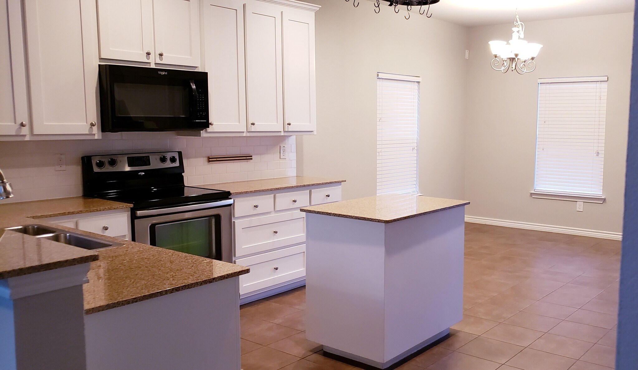 Kitchen w built-ins, island, walk-in pantry, pot rack and granite countertops - 3426 W 4th St
