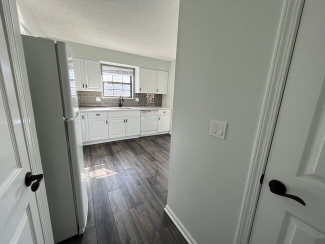 View of kitchen from back hallway/pantry/half bath - 14103 W 88th Terrace