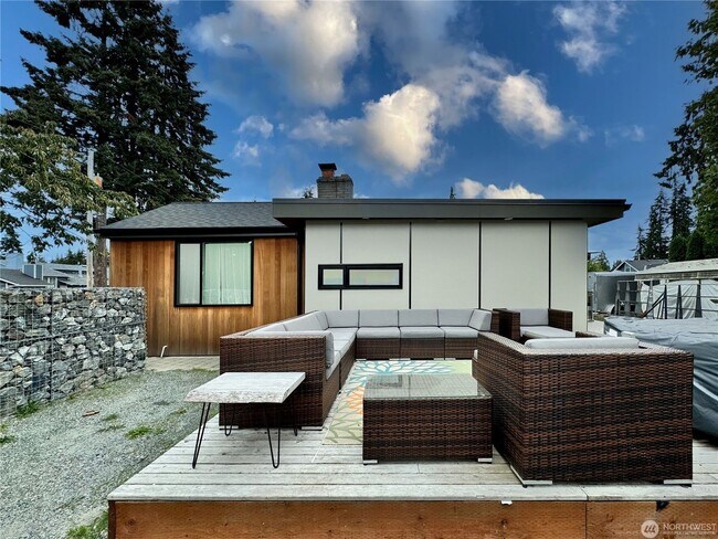 Building Photo - Remodeled 3 bdrm home on a large lot with 500 sq ft wrap around deck!