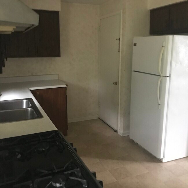 Kitchen with refrigerator - 1443 Maple Dr