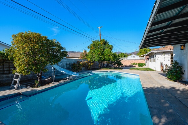Building Photo - Luxury Estate with Sparkling Pool & Elegant Amenities