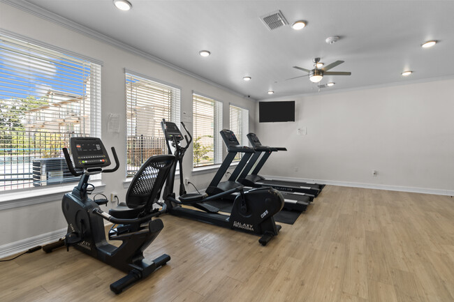 Gym overlooking the pool area - The Morrison Lofts