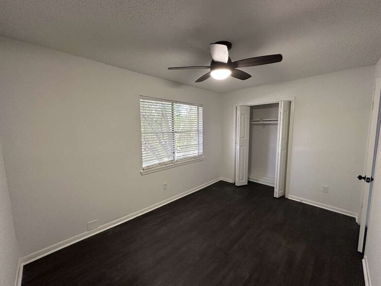 Guest Bedroom: window, brand-new ceiling fan & lighting, and closet. - 7700 Creekbend Dr