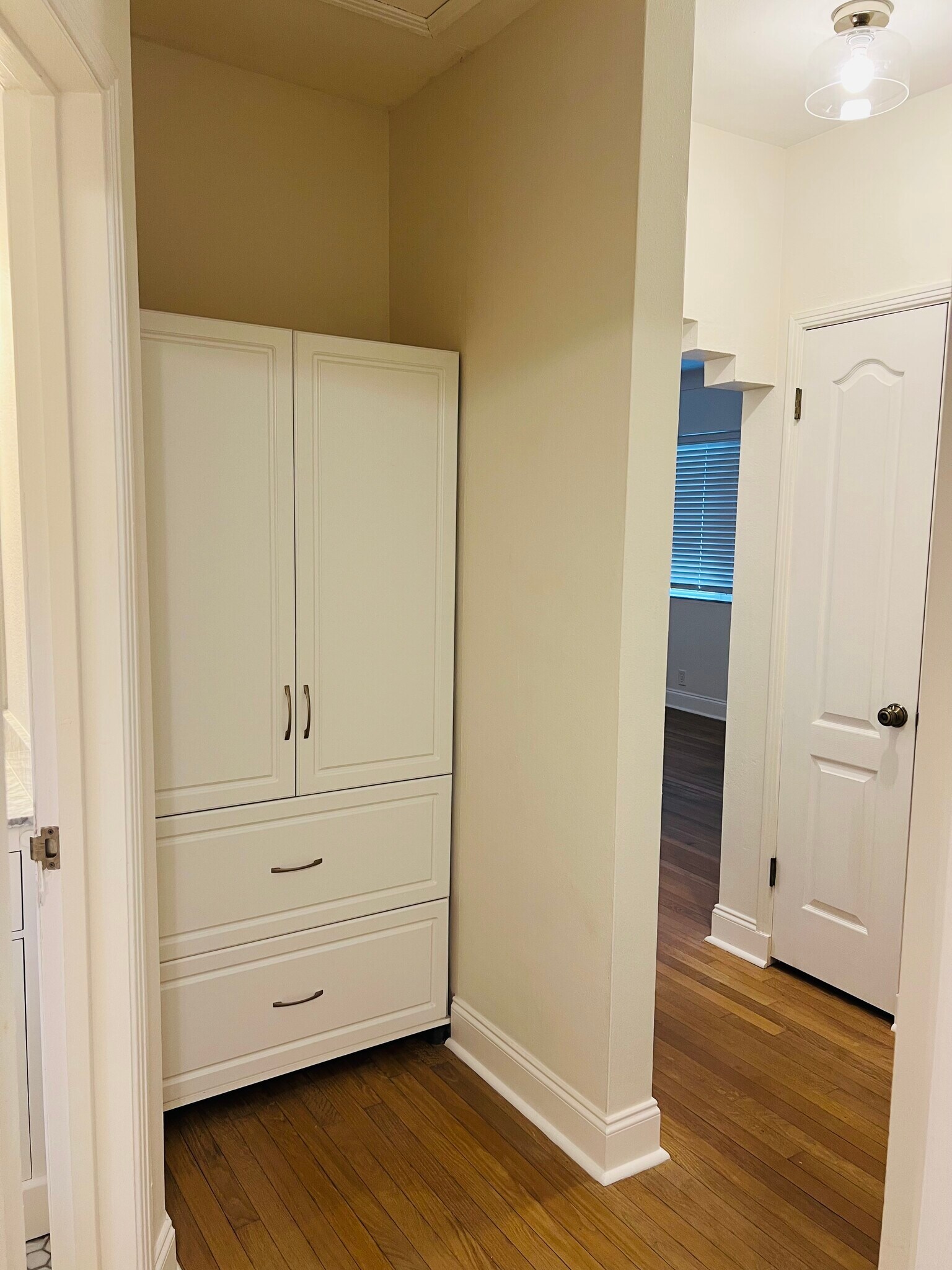 Hallway to guest bedrooms with built in storage - 6446 Dartmouth Ave N