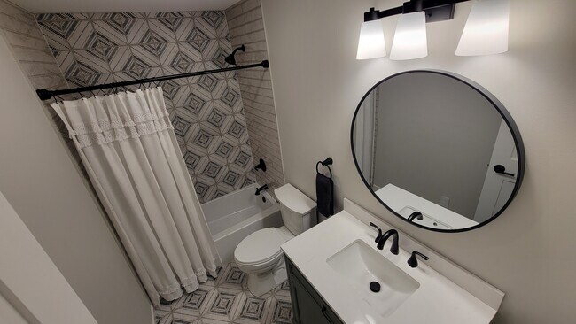 Main bathroom includes all new tile, tile tub surround, Kohler tub & Toilet, New Vanity and Faucets - 6305 49th Ave