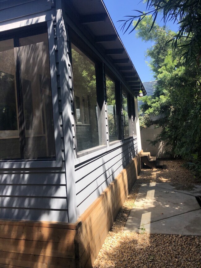 Sunny and green redwood clad sunroom offering numerous opportunities for entertaining and relaxing - 4228 Lockwood Ave