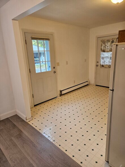 Inside the main entrance looking back. You see the where the linoleum and new vinal flooring meet. - 4304 Kateri Ln