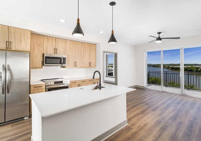 Enjoy culinary convenience at Modera Riverview with a spacious chef’s island featuring built-in storage. - Modera Riverview