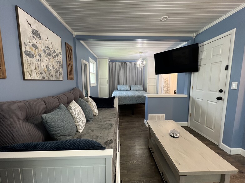 The swivel bracket on the t.v. allows you to watch from the couch or the bed! - 908 Lake Rd