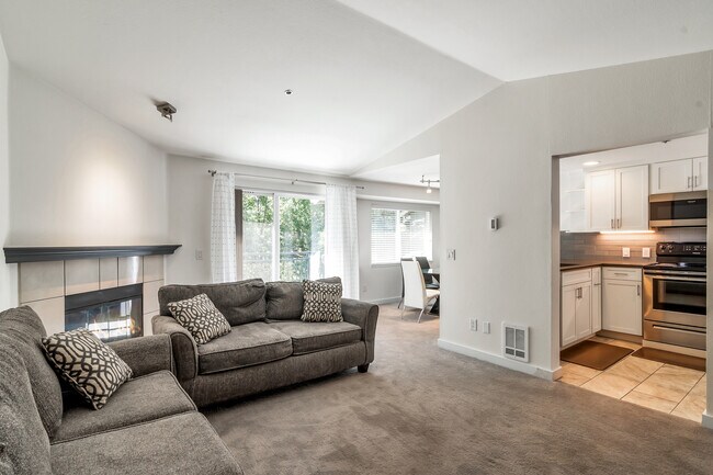 Living room with a view into the kitchen. - 19404 Bothell Way NE