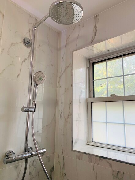 Rain and hand-held shower heads in the shower - 2227 10th St NW