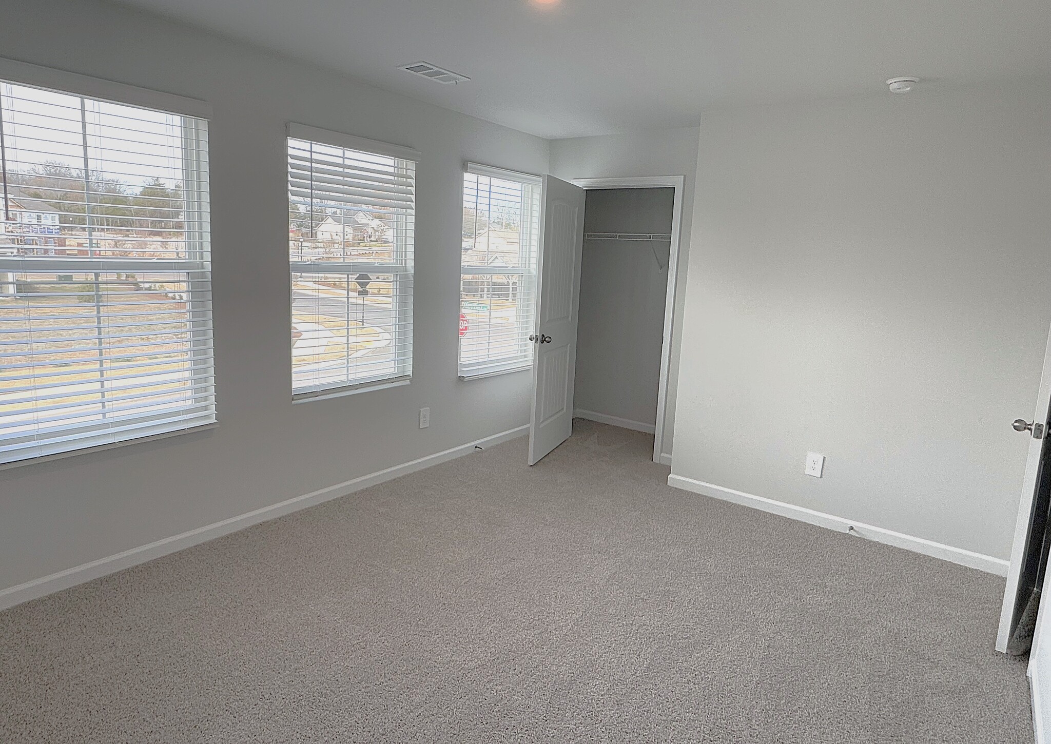 The second upstairs bedroom has three windows. - 403 Augustine Dr