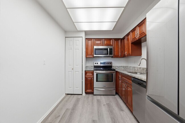 Building Photo - This expansive ground level residence is set within a serene, gated garden community surrounded b...