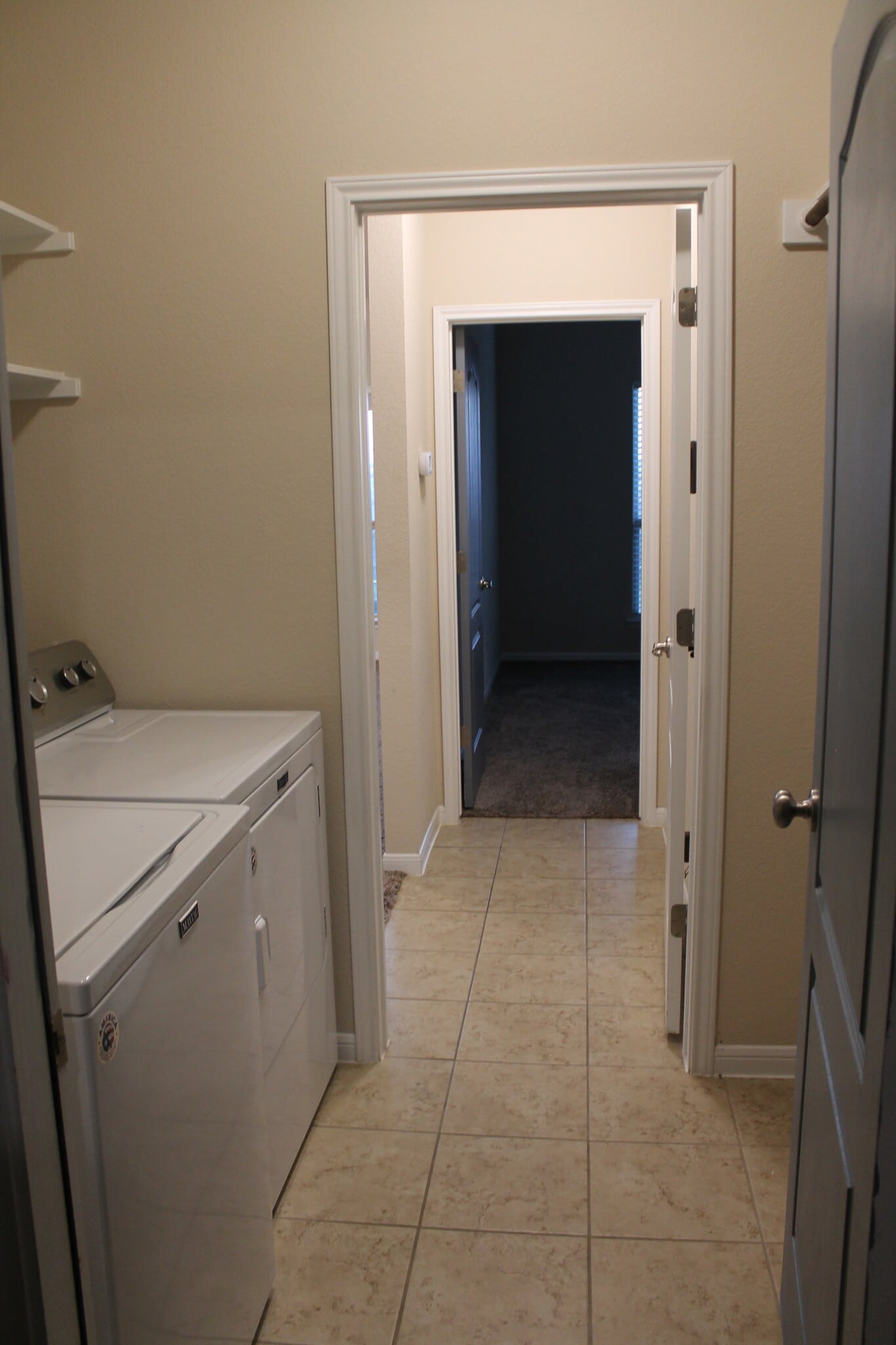 Galley-style laundry room which connects home to garage. - 1027 Aurora Grove Bnd