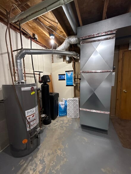Mechanical room with furnace, water heater, and water softener. - 9092 Goldenrod Ln N