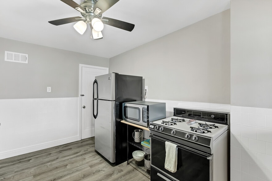 Appliance location, a sleek black stove is now in place. - 3443 Lawn Ave