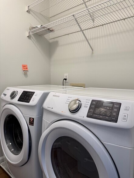 In condo unit laundry room with front load washer and dryer - 1133 Torrence Cir