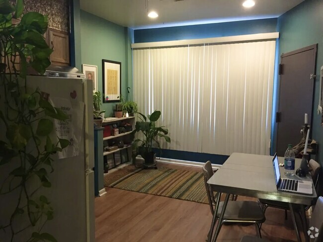 Kitchen area - angle/view from hallway area facing front window and apt entrance door - 1168 S 10th St