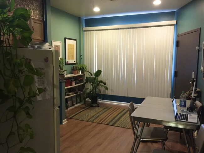 Kitchen area - angle/view from hallway area facing front window and apt entrance door - 1168 S 10th St