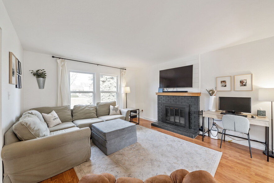 Bright and airy living area with large windows allowing ample natural light. - 3418 Stratton Dr