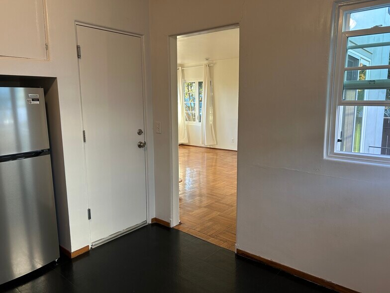 Kitchen, leads to living area (and the door to the garage). - 1903 Sacramento St