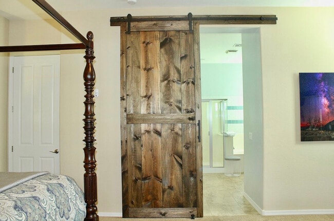 Barn door to primary bedroom. - 20892 W Eastview Way
