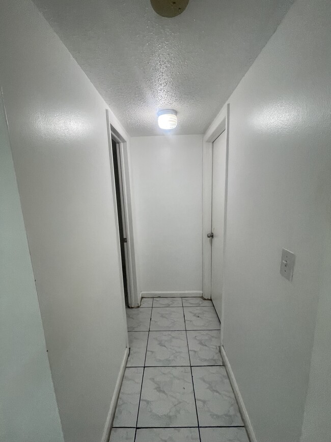 Hallway leading to half bathroom - 5100 SW 90th Ave