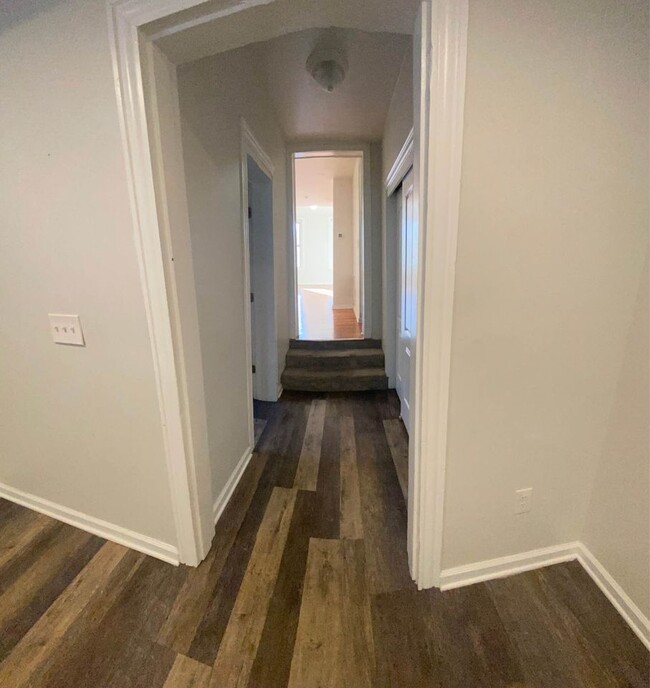 hallway with half bath and closet from kitchen to living room - 106 S 3rd St