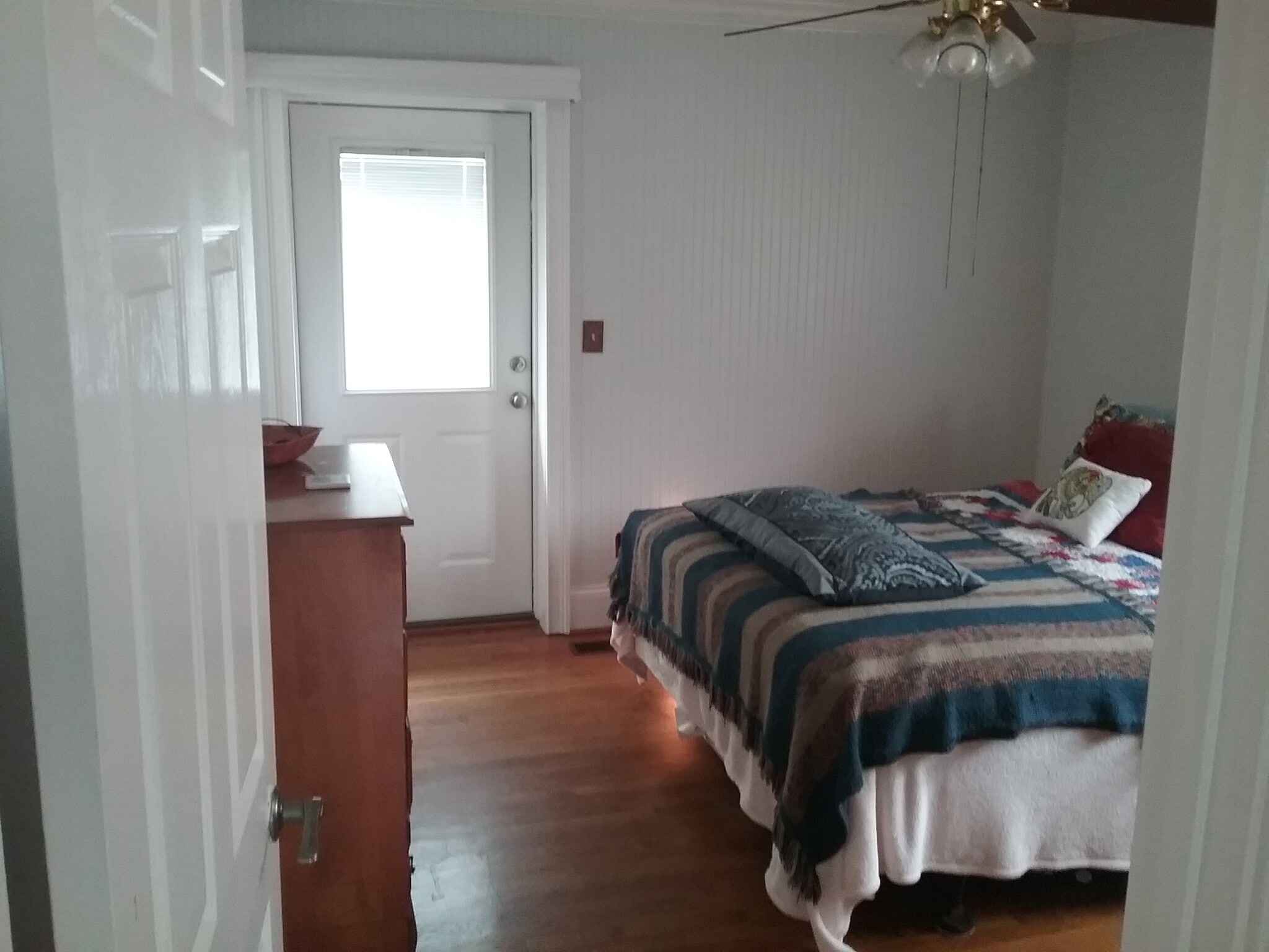 Master bedroom with private walk-out to backyard and attached half-bath - 701 Rosalyn Dr