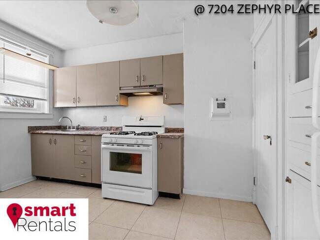 Building Photo - 7204 Zephyr Place - 2E