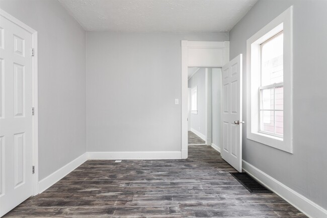 Downstairs bedroom, leading into kitchen. - 1150 Tecumseh St