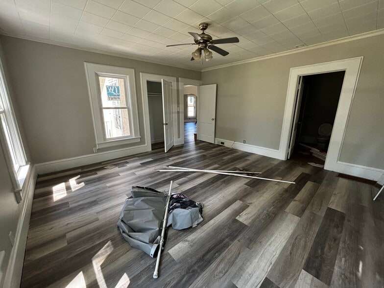 Main floor bedroom looking into living room and full bath - 420 E 2nd Ave