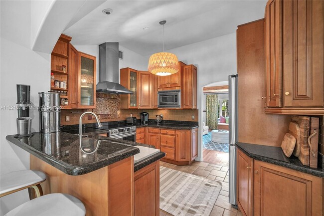 Open kitchen with raised granite counter for casual dining - 1109 NE 3rd St