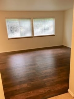 Gorgeous laminate flooring in Living room, which looks out to fenced backyard through new cordless white blinds. - 24615 104th Ave Ct E