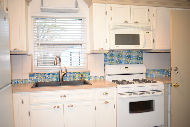 Kitchen with lots of cabinet space. Gas oven, garbage disposal and refrigerator included. - 307 El Toro St