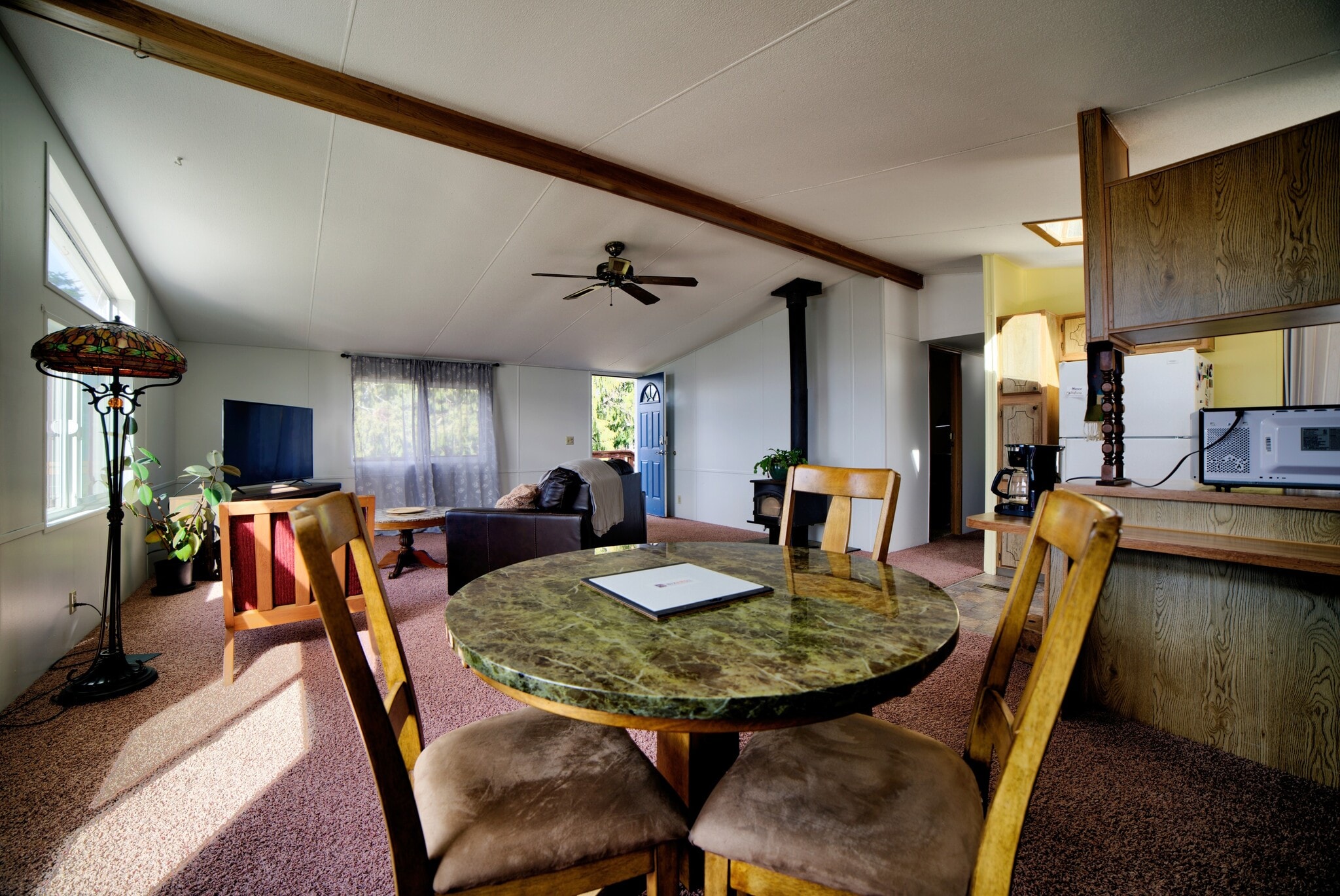Dining room is next to living room, four person table. - 5170 W Shore Rd