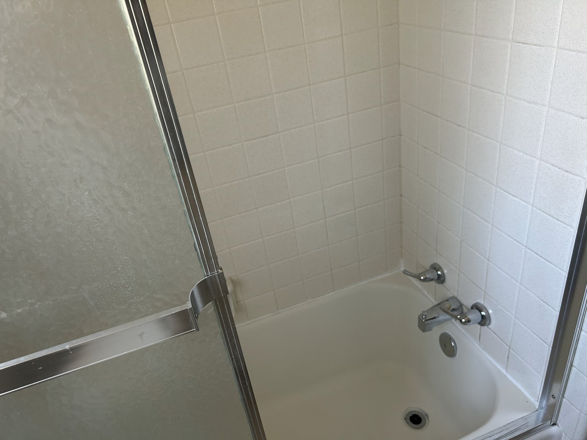 Cast iron tub with ceramic tile and sliding shower door - 208 Circular Rd