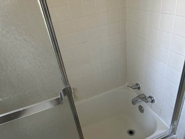 Cast iron tub with ceramic tile and sliding shower door - 208 Circular Rd